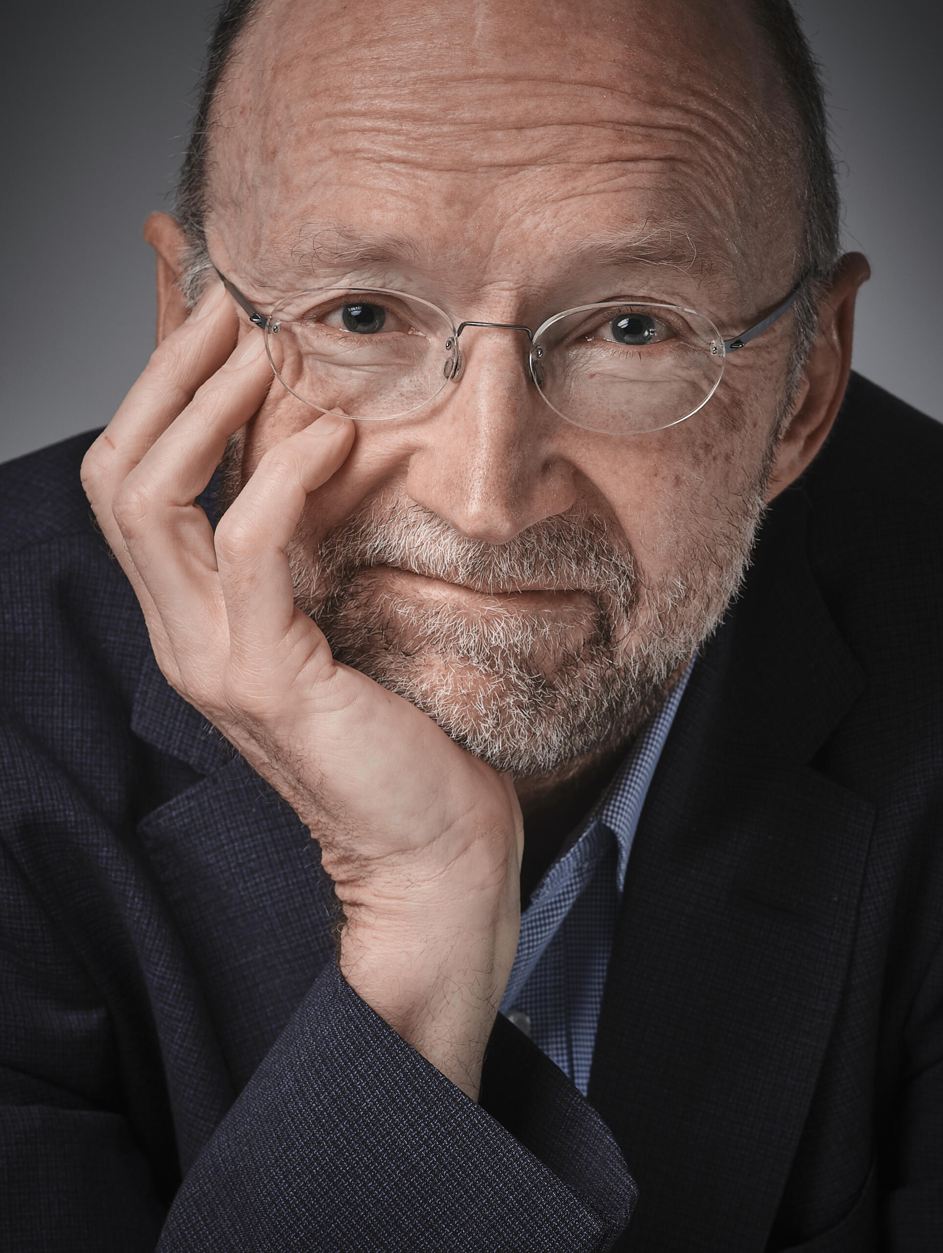Portrait photo of Matthew Baldwin. He is a white man in his 50s, bald, wearing glasses.