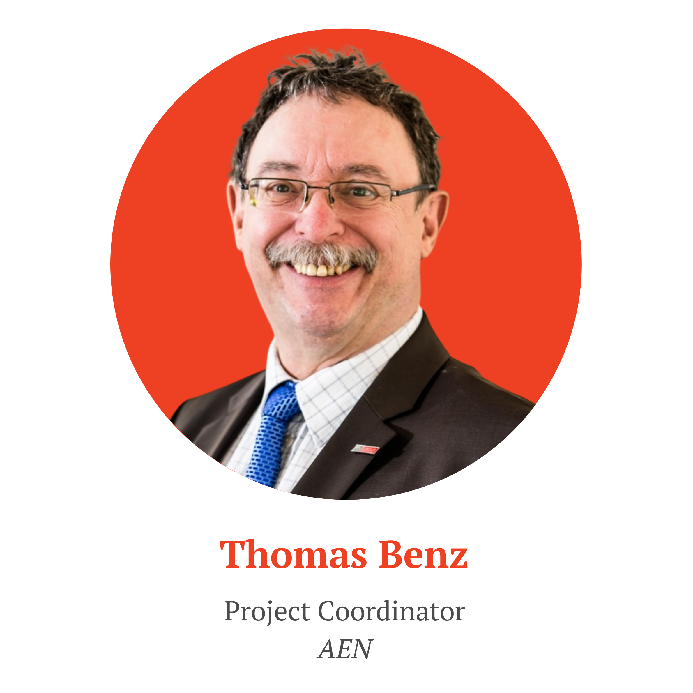 Portrait photo of Thomas Benz. He is a middle aghed man with a mustache and wearing black glasses