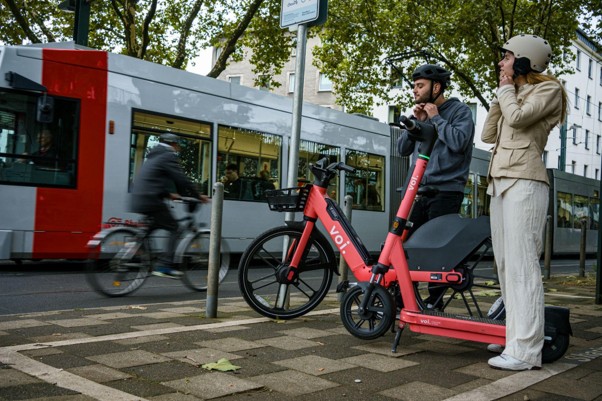 Riders using Voi e‑bikes as part of their daily journeys in a tram‑served corridor