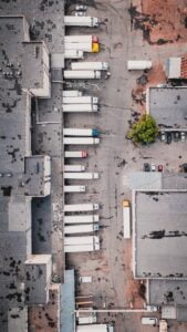 aerial view of trucks on gray commercial building during daytime